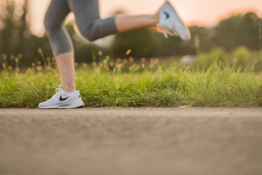 A woman running across grass