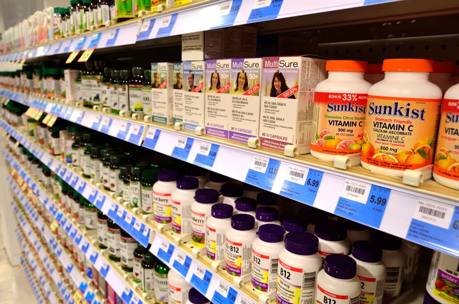 Supplement capsules beside their packaging