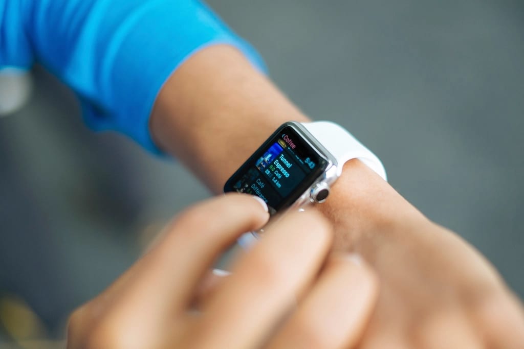 A person checking stats on a smartwatch
