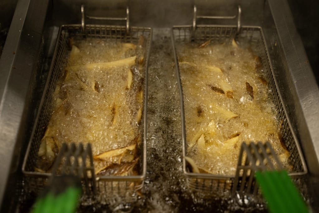 French fries cooking in a deep fryer