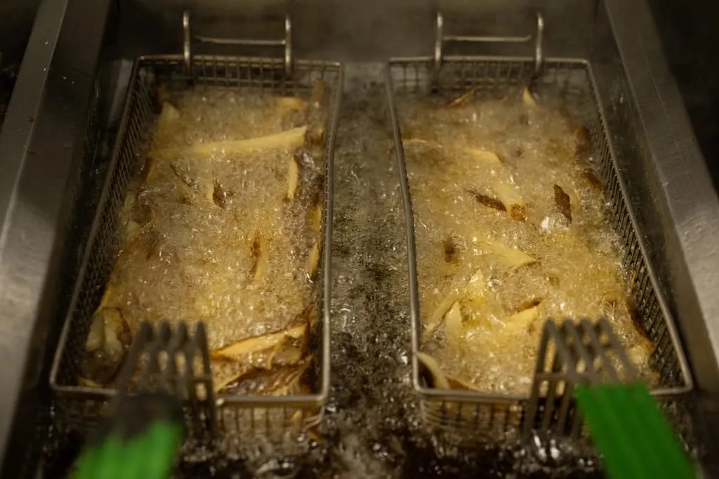 French fries cooking in a deep fryer