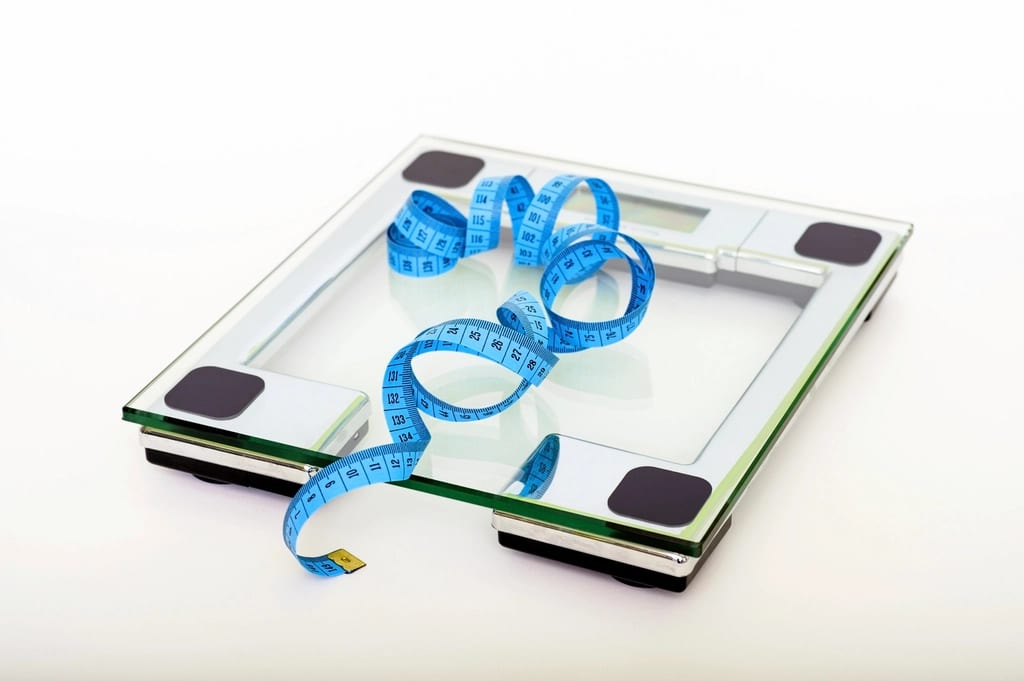 A bathroom scale and a measuring tape
